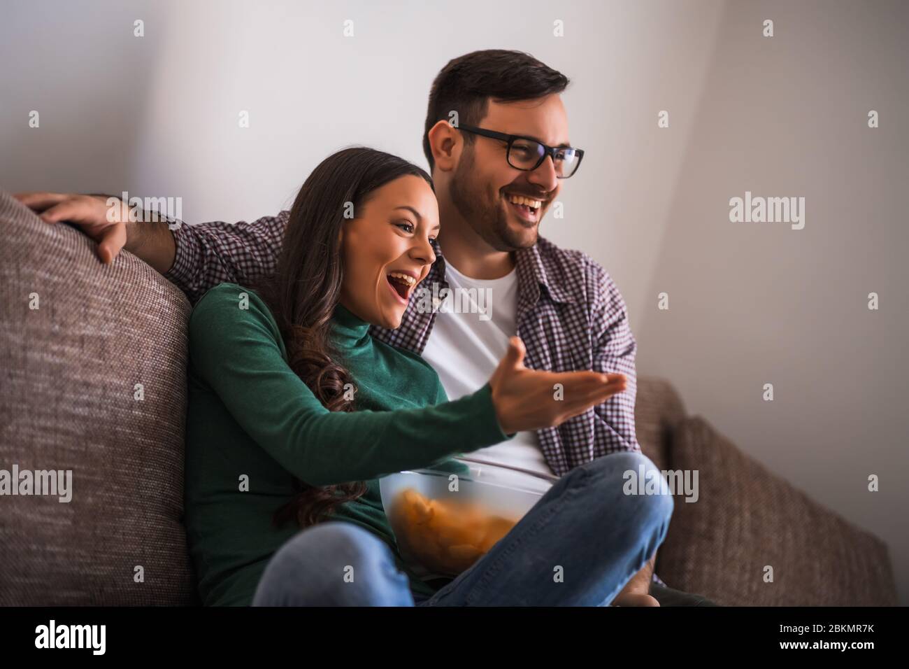 La coppia è rilassante a casa. Stanno guardando la tv. Foto Stock