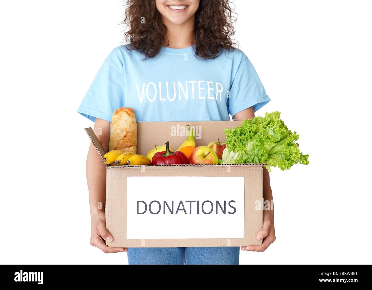 Donna sorridente corriere volontario tenendo in primo piano la casella delle donazioni di cibo sociale. Foto Stock