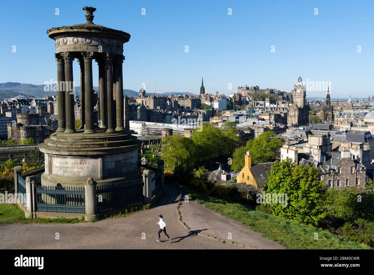 Edimburgo, Scozia, Regno Unito. 6 maggio 2020. Il sole ininterrotto e il tempo senza vento hanno dimostrato le condizioni belle per una ragazza jogger che si esercita quotidianamente durante il covid-19 a Calton Hill a Edimburgo oggi. La famosa destinazione turistica era praticamente deserta, con solo joggers locali e camminatori per cani fuori godendo il sole. Iain Masterton/Alamy Live News Foto Stock