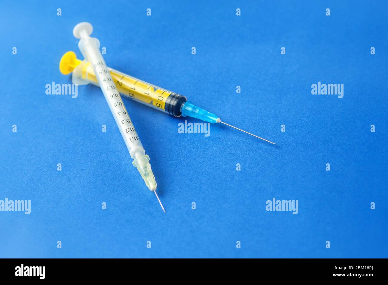 Siringhe mediche su sfondo blu. Siringa per insulina Foto stock - Alamy