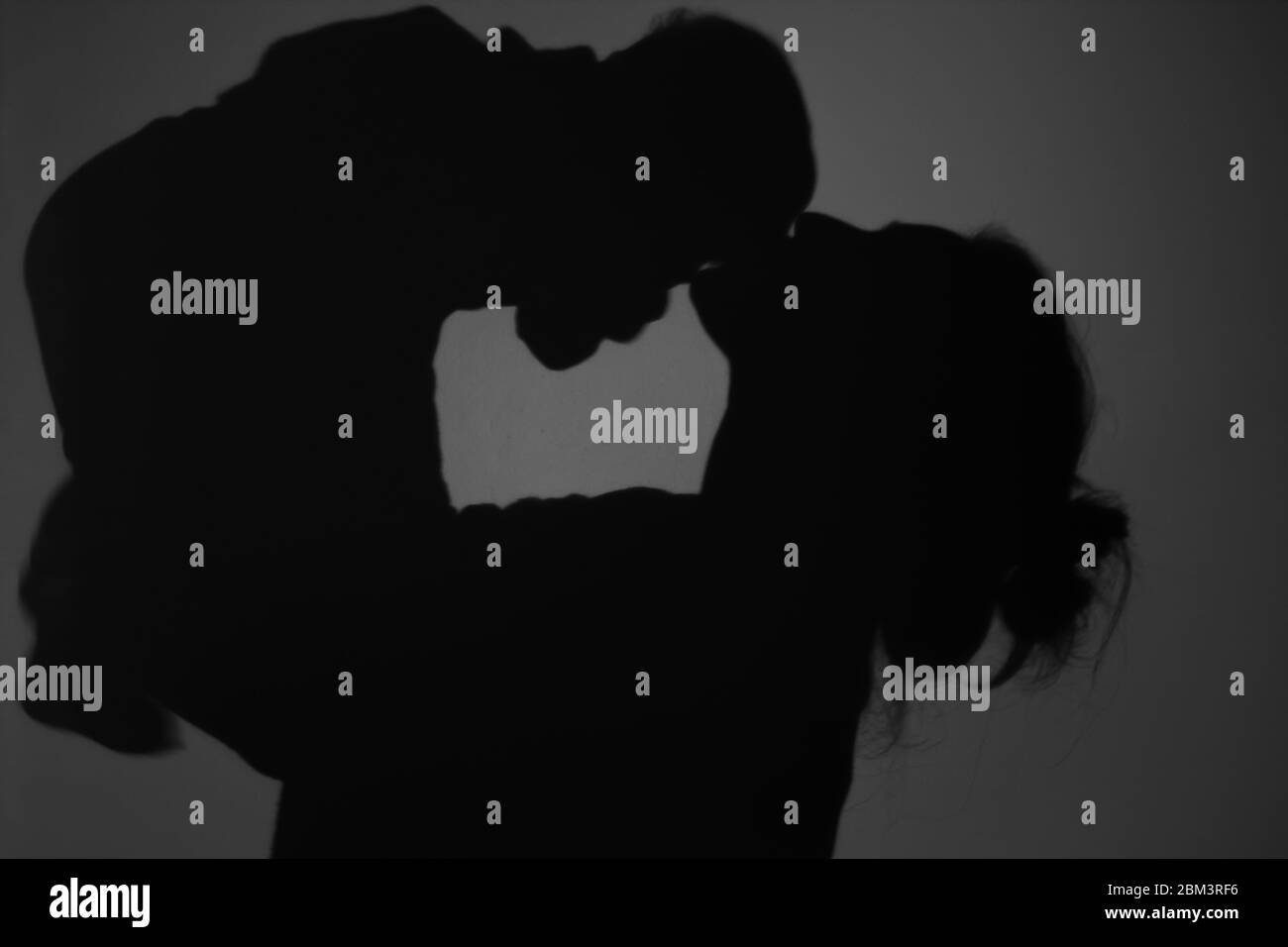 Silhouette di Madre e Bambino felice. Mamma bacia il bambino, felice concetto di Festa della mamma Foto Stock