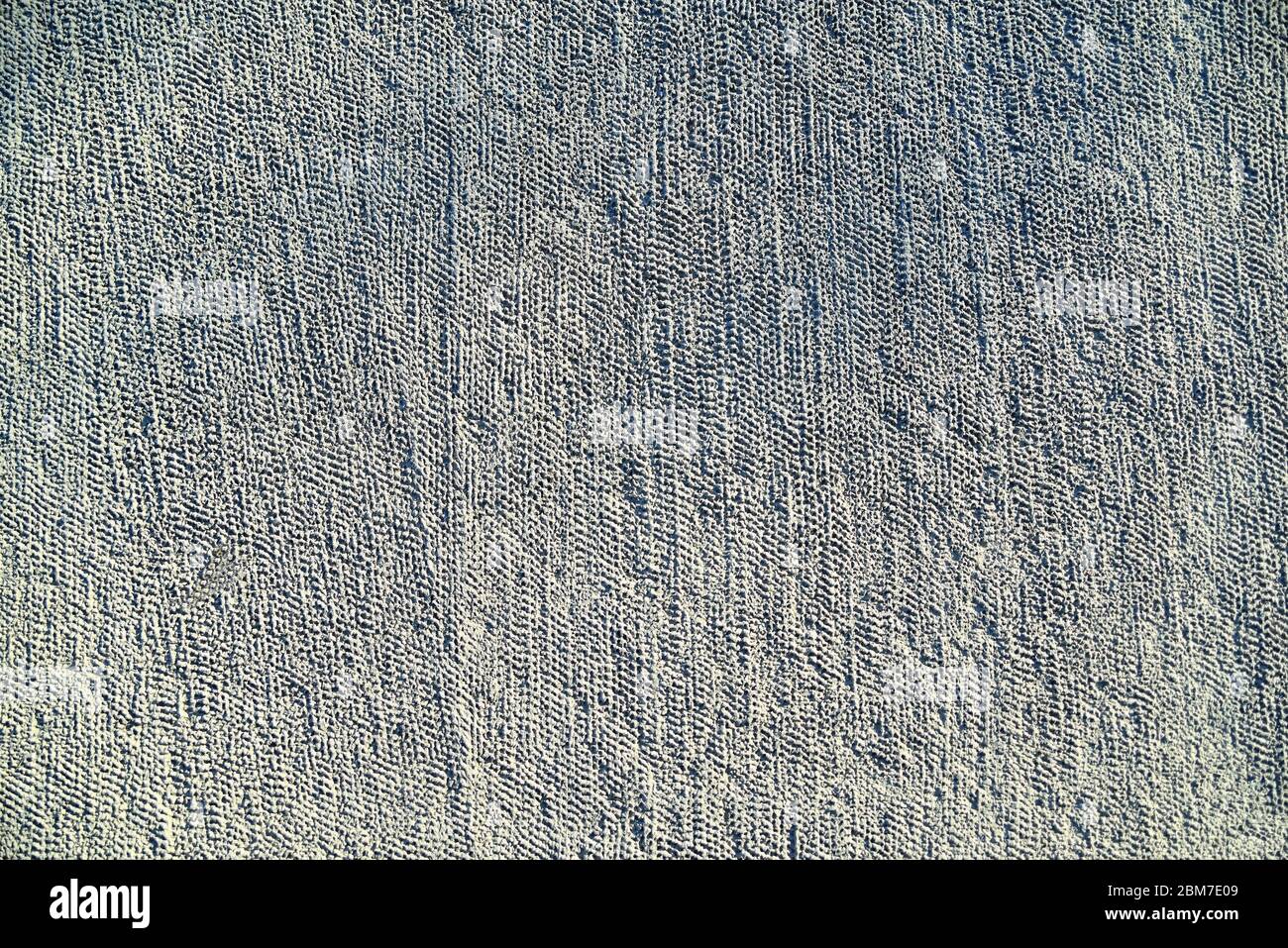 fondo grigio non omogeneo in calcestruzzo, tessuto poroso e ruvido irregolare Foto Stock