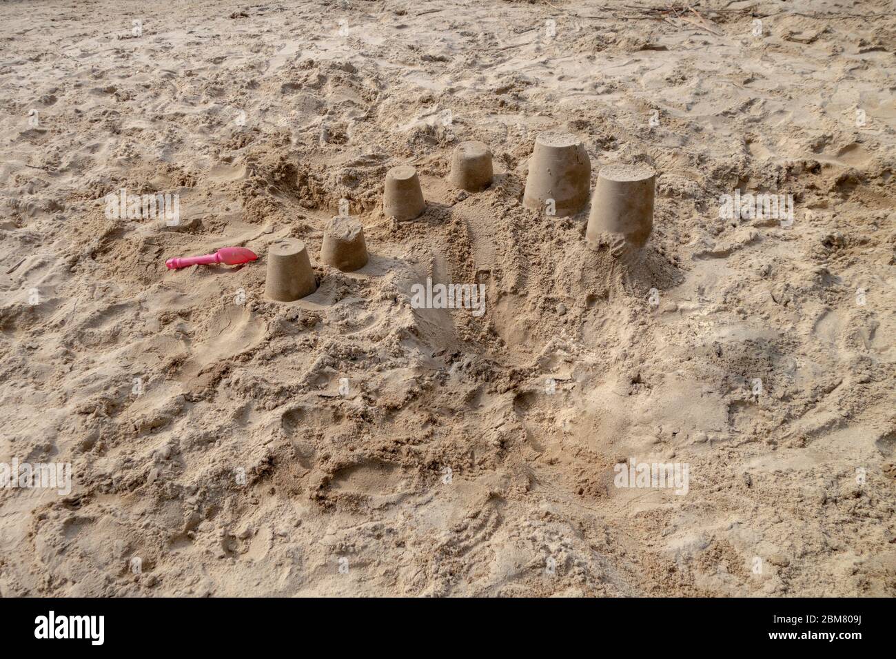 caslles di sabbia formato secchio sulla spiaggia sabbiosa della riva estiva Foto Stock