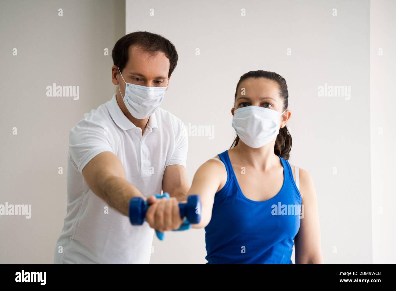 Physio Therapy Physical Trainer in Face Mask Foto Stock