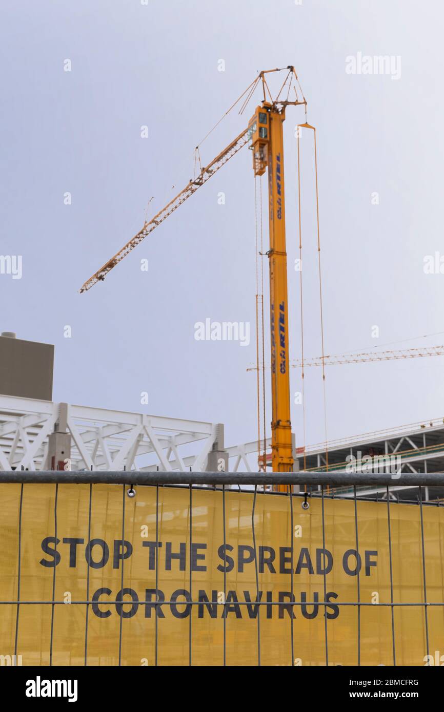 Veldhoven, Paesi Bassi, 8 maggio 2020. Fermare la diffusione del virus Corona, un testo su un cartello giallo di informazioni testili in un cantiere con Foto Stock