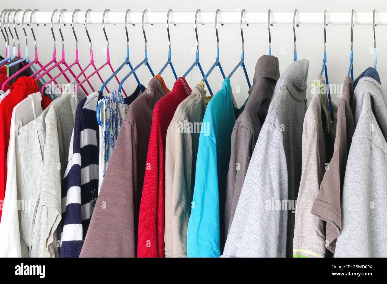 Abbigliamento da uomo e da donna su staffe in silicone nell'armadio. Le stesse spalle. Organizzazione di storage. Ordine e pulizia. Quarantena, se Foto Stock