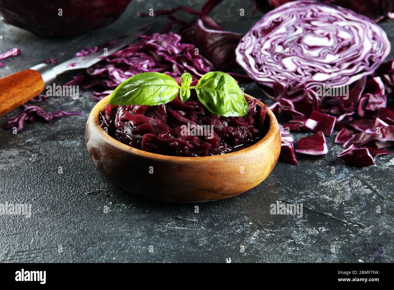 Cavolo rosso sottaceto e cavolo rosso fresco tritato. Preparare verdure a fette per la cottura di insalata di cavolo viola o insalata di cavolo. Concetto di cibo fresco fatto in casa. Foto Stock