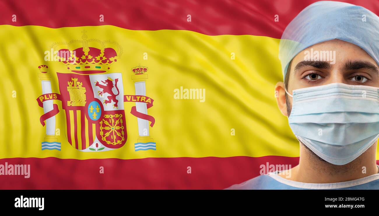 Sanità in Spagna, concetto di focolaio di coronavirus. Medico con equipaggiamento protettivo sullo sfondo della bandiera spagnola. Foto Stock
