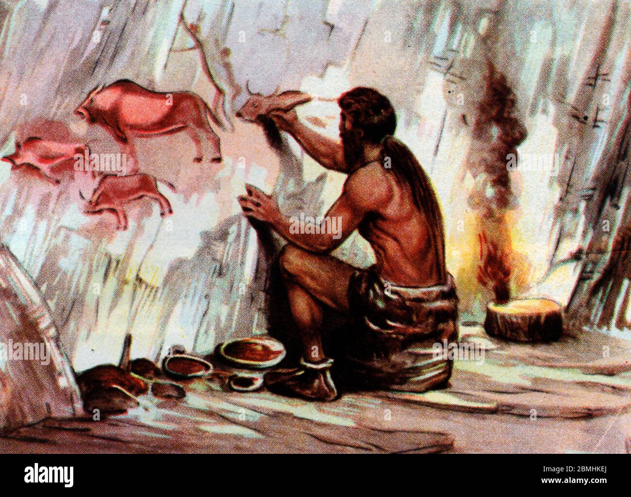 Prehistoire, paleolithique : un homo sapiens dessine des animaux sur la paroi d'une grotte (peinture rupestre) - Illustration anonyme tiree de 'vita Foto Stock