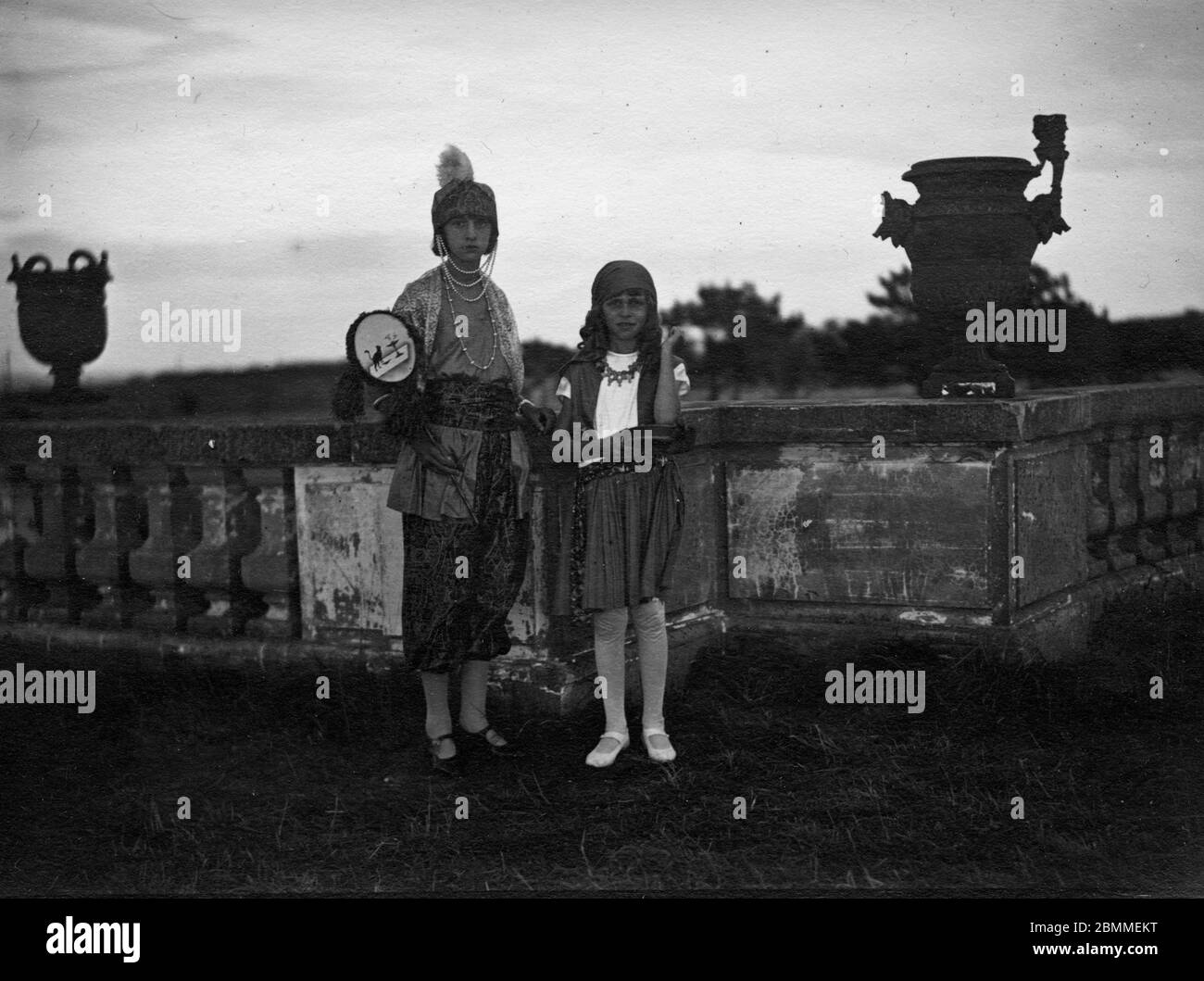 Portrait de deux petites filles de la borghesia parisienne, deguisees, a l'occasione d'une fete dans le parc d'un Chateau pres de Paris (Chantilly ?) Foto Stock