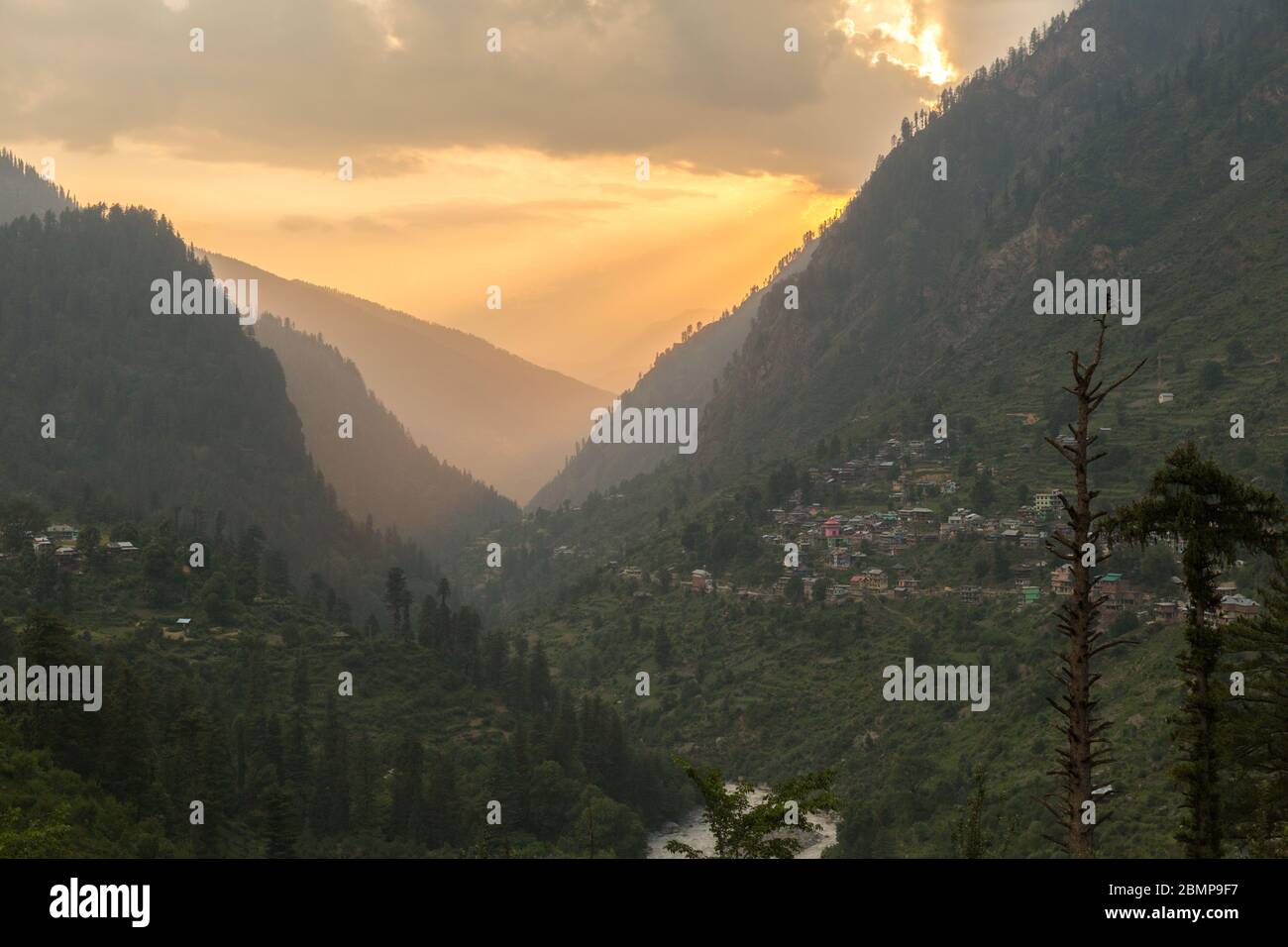 Ultimo sole raggi in serata passando attraverso la valle Parvati in Himalaya vicino Manali, Himachal Pradesh; India Foto Stock
