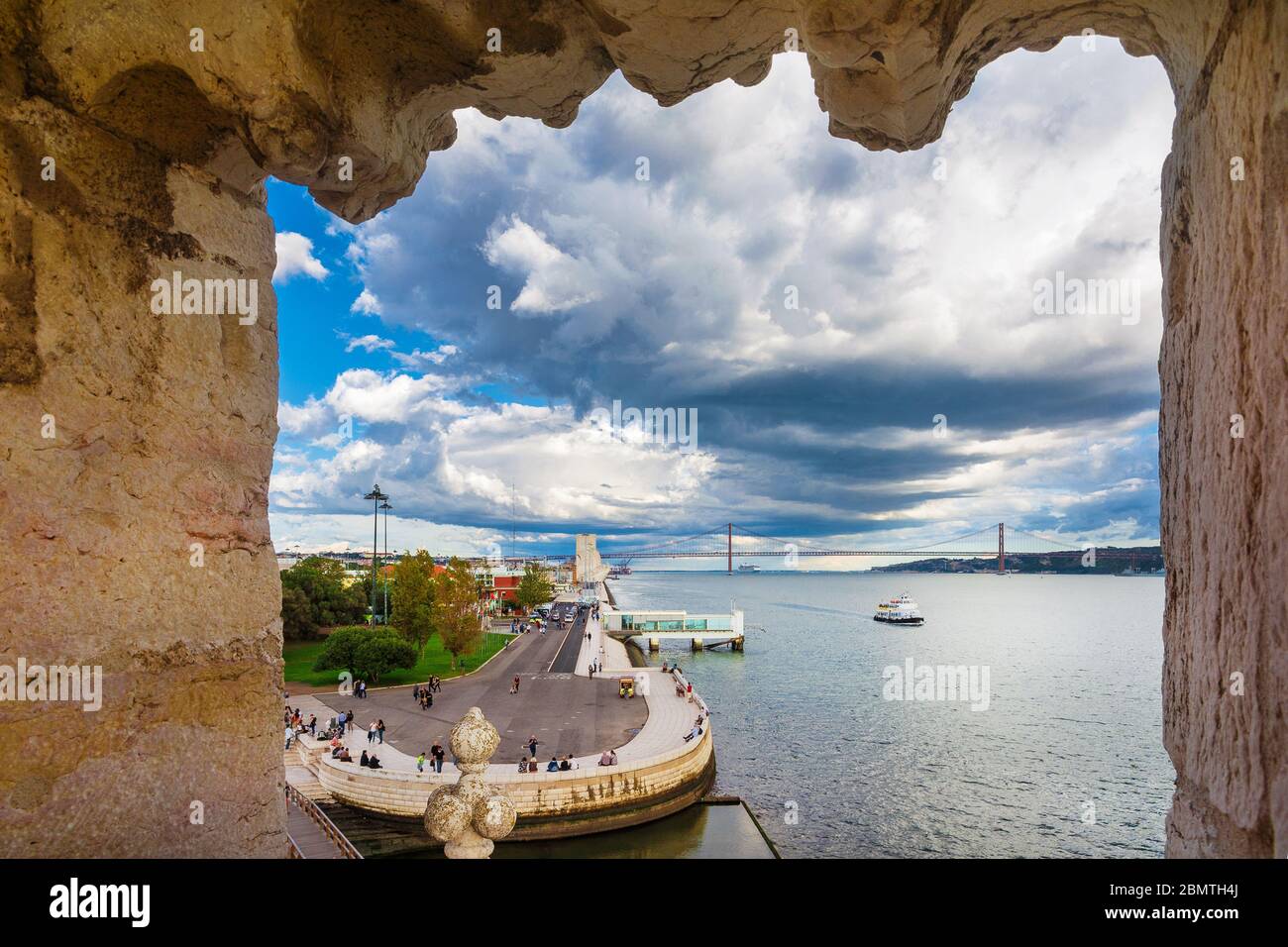 Vista del famoso Prado dos Descrobrimentos, 25 de Abril Bridge e il fiume Tago con le nuvole tempeste dalla Torre di Belem Foto Stock