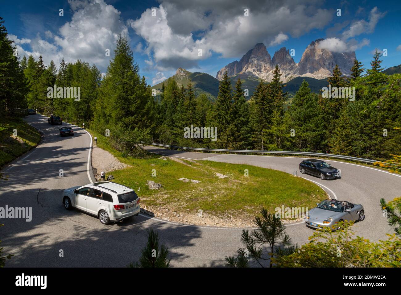 Traffico su tornanti sul Passo Pordoi con sfondo montano, Alto Adige, Dolomiti Italiane, Italia, Europa Foto Stock