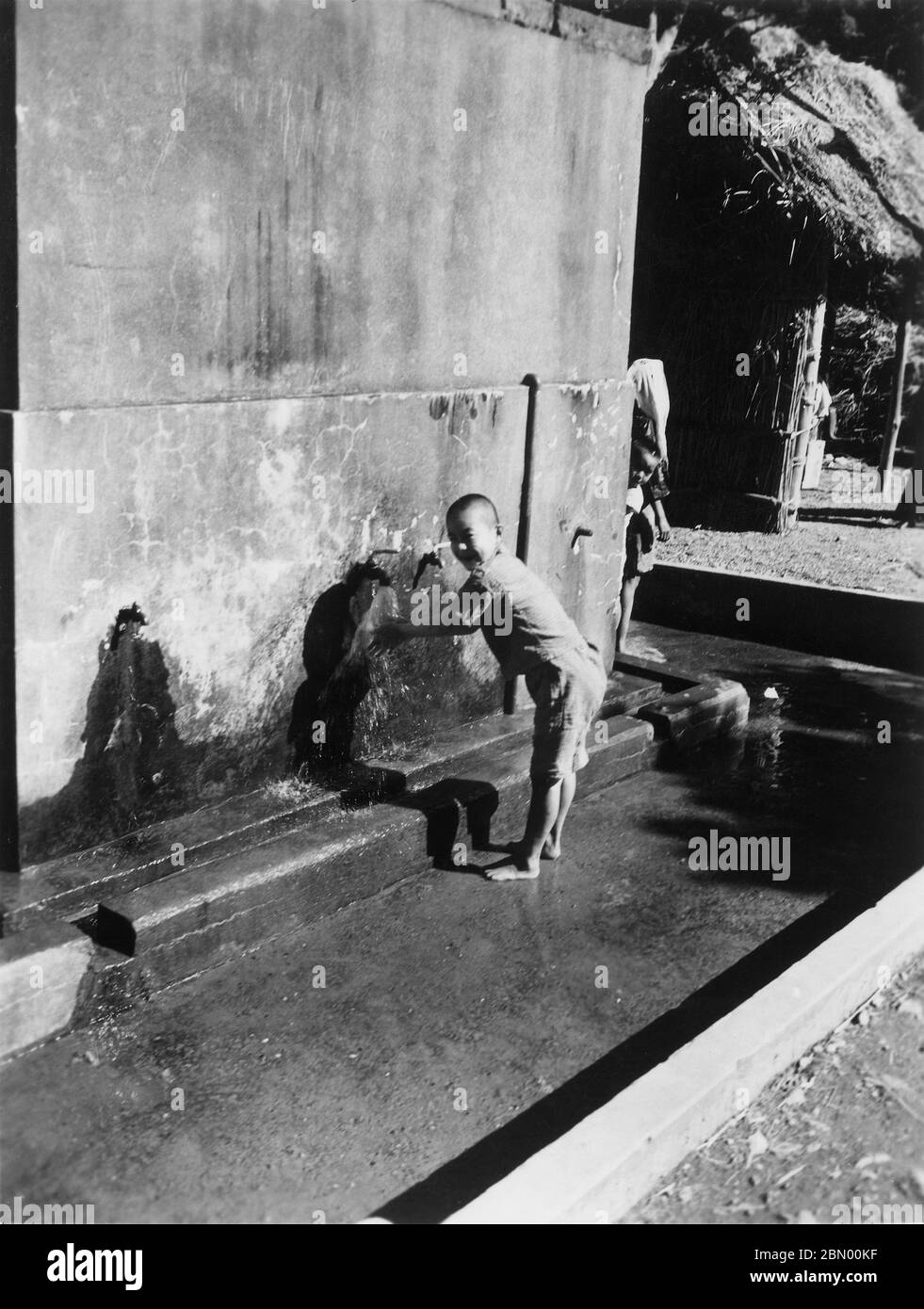 [ 1946 Giappone - Okinawan Boy ] - Okinawan ragazzo lavandosi le mani, 1946 (Showa 21). stampa in argento gelatina del xx secolo. Foto Stock