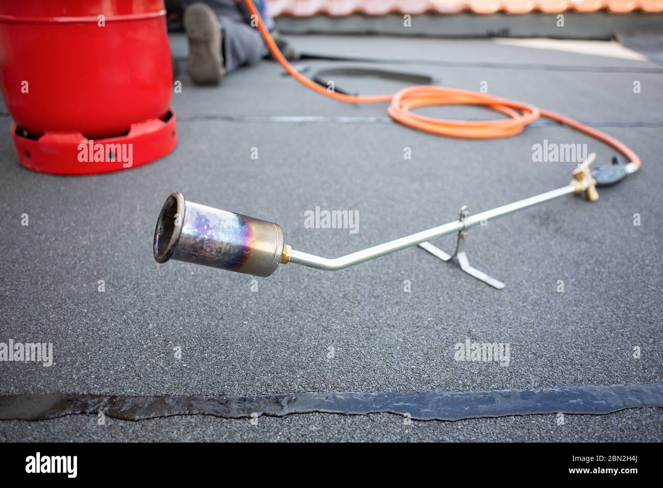 Torcia a gas e bombola su un tetto piatto Foto Stock