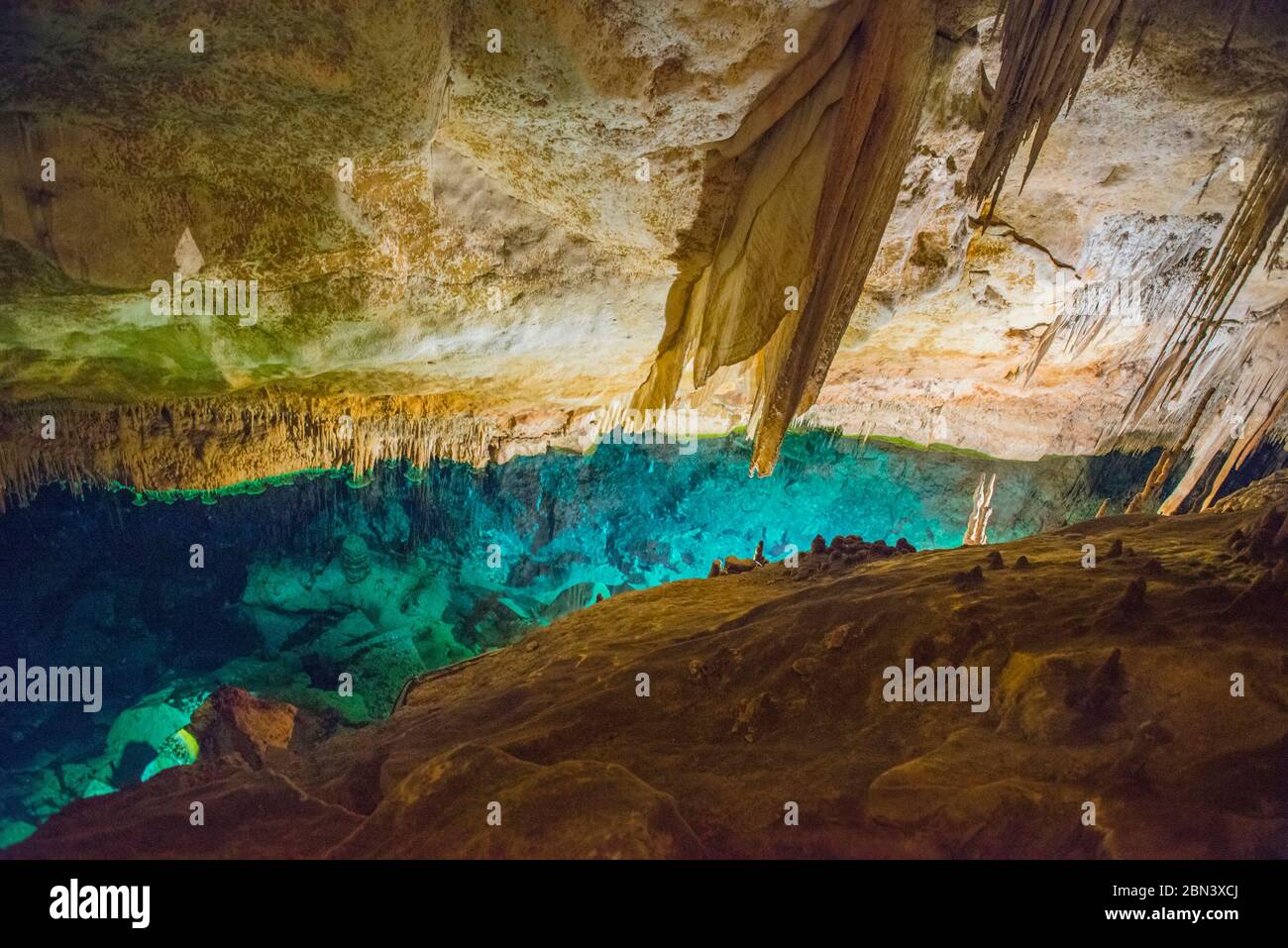 Grotte illuminate di stalattiti in Spagna sull'isola di Maiorca. Illuminazione multicolore delle grotte. Bella grotta. Stalattiti in vecchia grotta. Rosso, gr Foto Stock