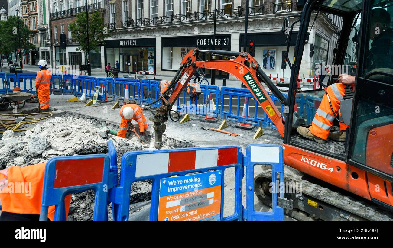 Londra, Regno Unito. 12 maggio 2020. Lavoratori edili in un sito di Oxford Street. Secondo l'Ufficio di statistica Nazionale (ONS), i lavoratori edili maschi sono tra quelli con il tasso di mortalità più elevato per coronavirus. Credit: Stephen Chung / Alamy Live News Foto Stock