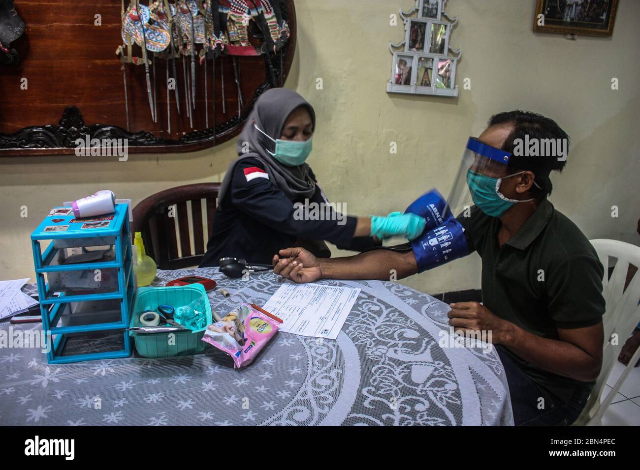 Sleman, Yogyakarta, Indonesia. 12 maggio 2020. I funzionari della Croce Rossa indonesiana stanno misurando la pressione sanguigna dei cittadini che partecipano a un programma di donatori di sangue condotto dalla Croce Rossa indonesiana a Sleman. Le scorte di sangue nella Croce Rossa Indonesiana sono diminuite drasticamente a causa di focolai di virus della corona o del COVID Pandemic- 19. Credit: Slamet Riyadi/ZUMA Wire/Alamy Live News Foto Stock