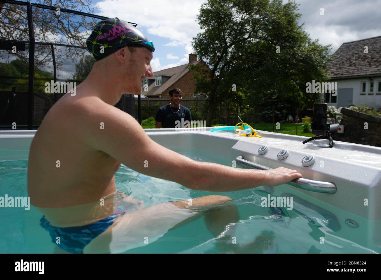 Il nuotatore britannico Luke Greenbank prende i treni in piscina nella casa di ed Baxter a Loughborough, sorvegliato dal pullman Mel Marshall. La piscina era fornita da Jacuzzi in collaborazione con le vasche idromassaggio del Bedfordshire per consentire ai nuotatori olimpici del GB di continuare ad allenarsi a casa per Tokyo 2021 durante l'attuale blocco del Regno Unito. Foto Stock