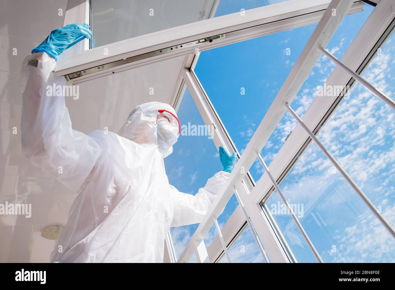 Medico stanco rischio biologico dopo un duro spostamento in ospedale, il coronavirus guarda il cielo blu Foto Stock