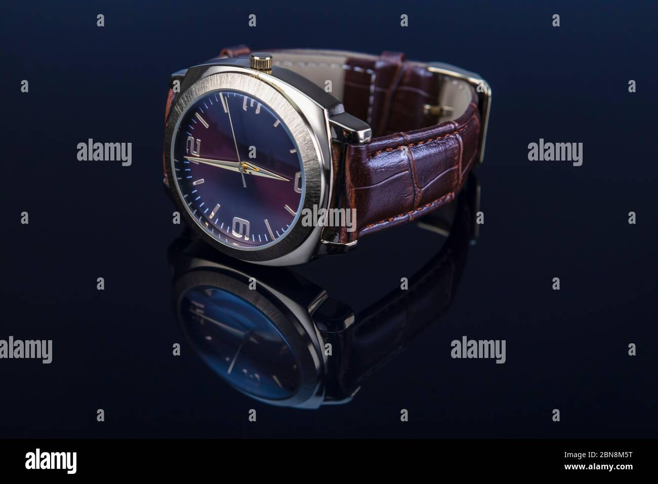 Orologio da polso uomo con bracciale in pelle su sfondo nero lucido. Foto Stock