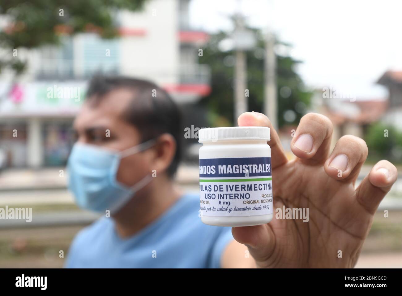 13 maggio 2020, Bolivia, Santa Cruz: Un uomo con una guardia della bocca mostra una lattina di capsule di ivermectina come esce dalla farmacia. L'antiparassitario divenne la nuova speranza nel paese sudamericano dopo l'annuncio dei risultati di uno studio preclinico australiano. Dopo che i rapporti dello studio sono stati trasmessi in televisione, la gente ha fatto il loro senso alla farmacia. "Vorrei acquistarlo come precauzione. Sarà più costoso dopo," ha detto un uomo in piedi in linea. Nessuno nella sua famiglia aveva mostrato sintomi della malattia di Covid-19. "Mia moglie mi ha mandato qui. Lo stiamo facendo solo come misura preventiva", ha Foto Stock