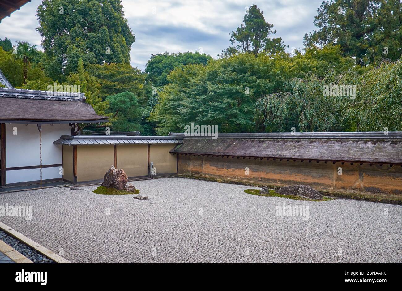 La vista del famoso giardino Zen del tempio Ryoan-ji - il paesaggio secco (karesansui) giardino di roccia, composto da 15 pietre circondate da onde di ghiaia bianca. Foto Stock