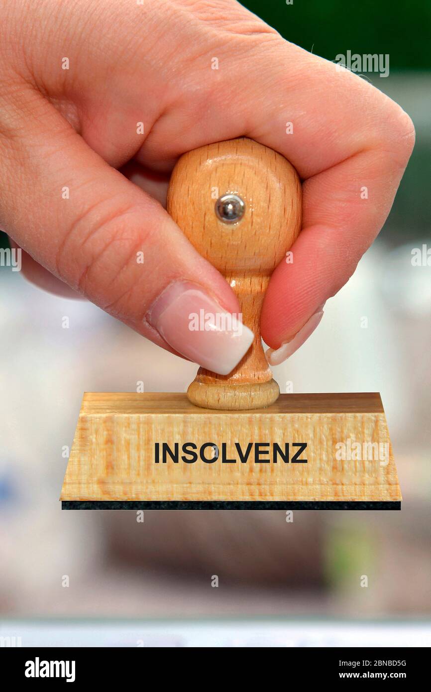 Timbro in mano di una donna scritta Indolvenz, insolvenza, Germania Foto Stock
