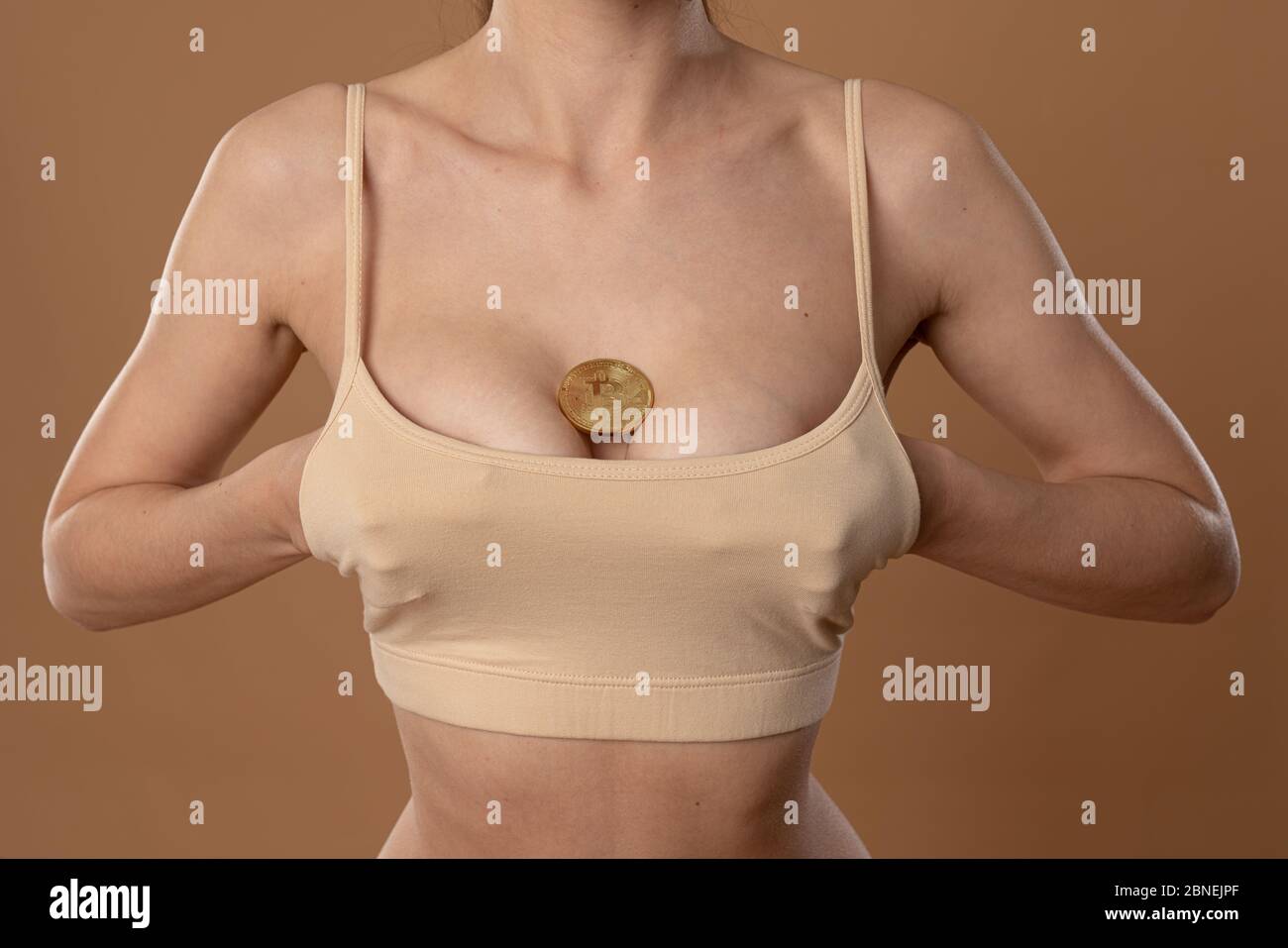 Primo piano foto di giovane femmina che tiene le mani sotto il reggiseno  beige Foto stock - Alamy