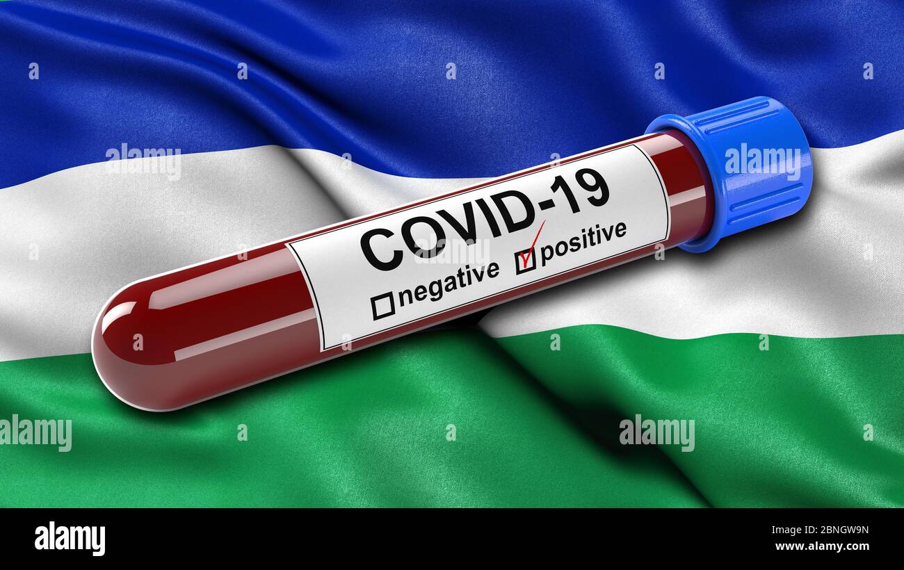 Bandiera del Lesotho che ondola nel vento con una provetta per il test ematico Covid-19 positiva. Foto Stock