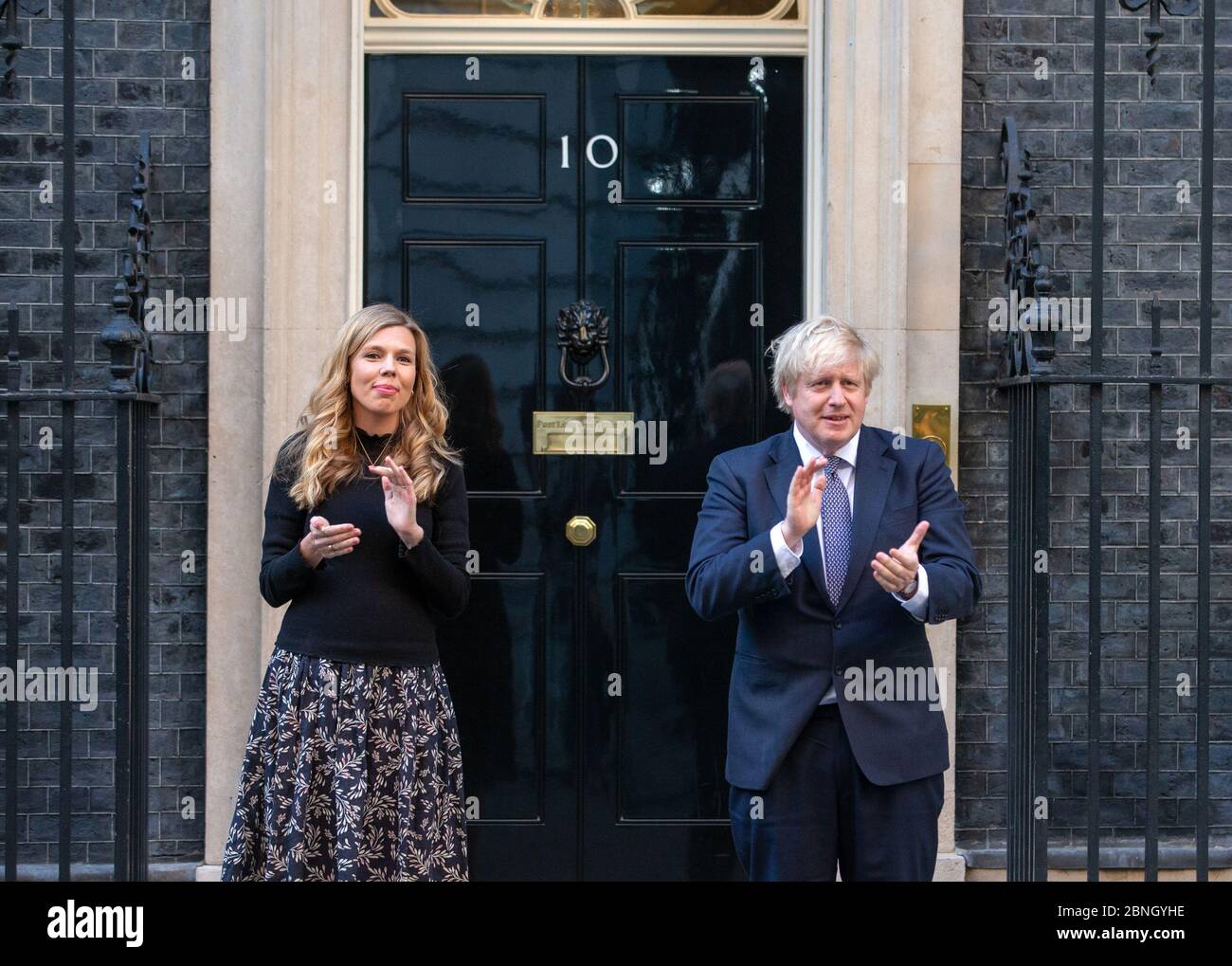 Il primo ministro, Boris Johnson, è Unito sui gradini di Downing Street 10 dal fidanzato Carrie Symonds a 'Clap for Carers' che sostiene l'NHS. Foto Stock