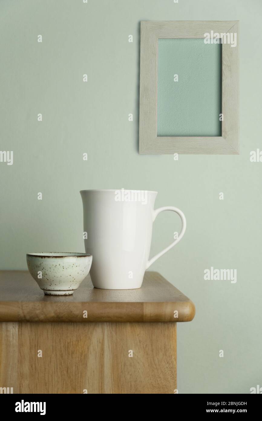 tazza di ceramica bianca e tazza da tè su tavola in legno naturale con cemento blu vintage e parete grigia cornice per cibo bevanda e sfondo casa Foto Stock