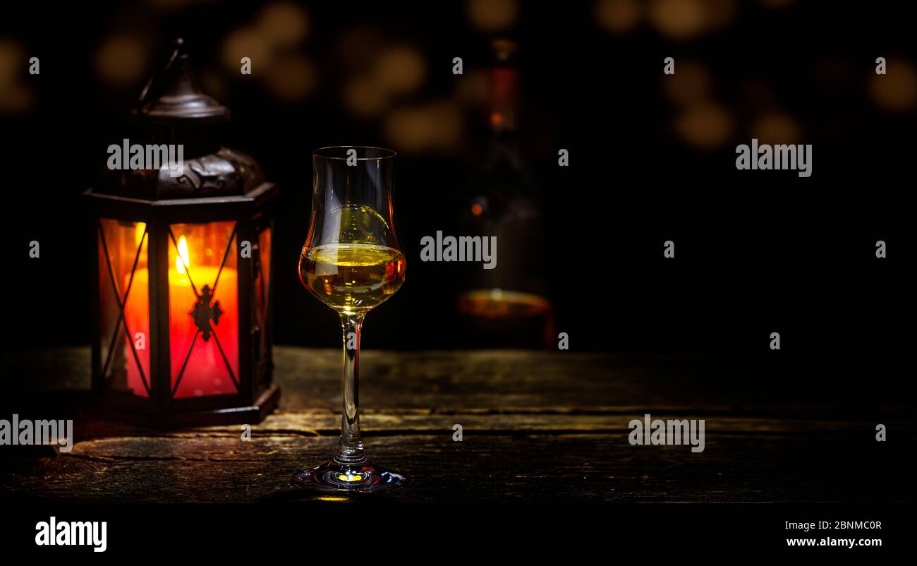Bicchiere di whisky, candele, pub, atmosfera accogliente Foto Stock