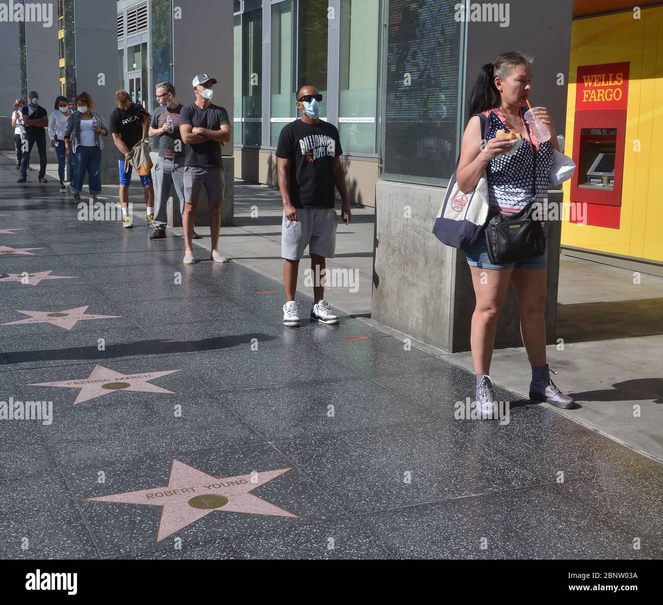 Los Angeles, Stati Uniti. 16 maggio 2020. Gli acquirenti, con e senza maschere facciali, aspettano in fila al Trader Joe's su Vine Street nella sezione Hollywood di Los Angeles venerdì 15 maggio 2020. I funzionari della città e della contea hanno detto che i residenti devono indossare rivestimenti per il viso quando si va all'aperto. Strutture ricreative come centri equestri, campi da tennis e da sottogallo e giardini comunitari riaperti venerdì, con restrizioni tra cui coperture viso, distensione sociale e limiti per i visitatori. Foto di Jim Ruymen/UPI Credit: UPI/Alamy Live News Foto Stock