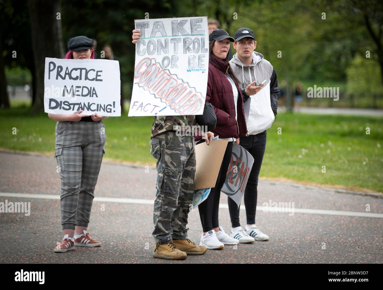 I membri del pubblico si riuniscono a Glasgow Green per protestare contro le restrizioni di blocco del coronavirus. Foto Stock