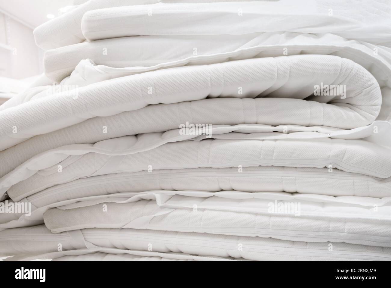 Pila di materassi bianchi in camera. Primo piano Foto Stock