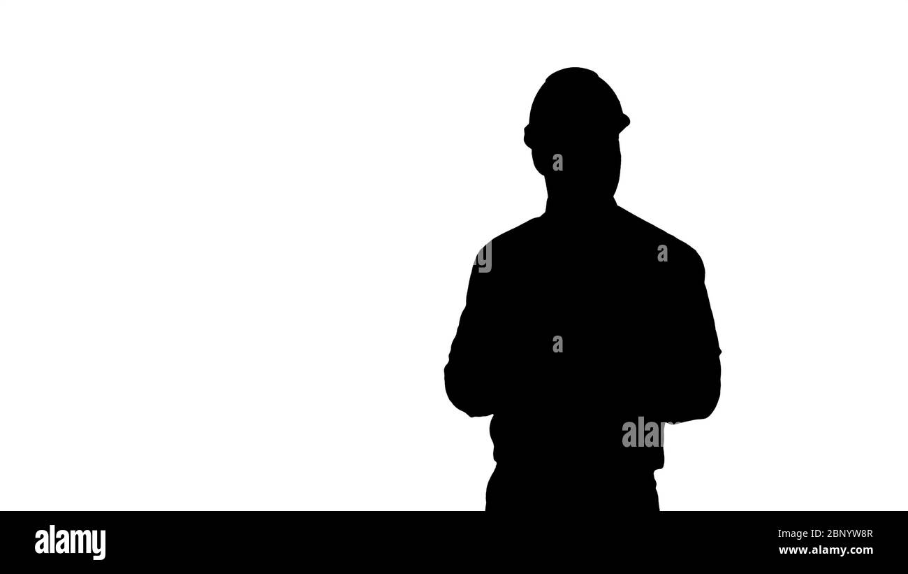 Silhouette uomo in casco e abiti formali che si guardano intorno e fanno note. Foto Stock