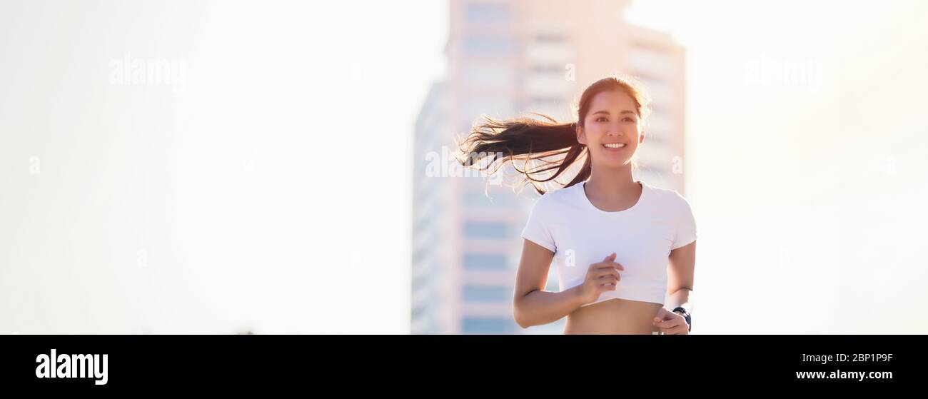 Sorridente Asian Young fitness sport donna running e sportivi formazione persone in una zona urbana, stile di vita sano e concetti sportivi Foto Stock