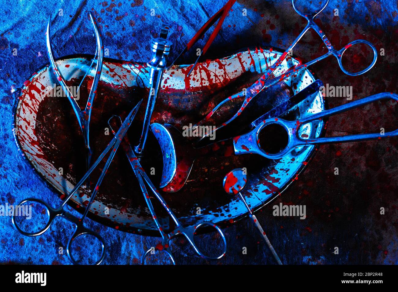 Gli utensili medici e gli attrezzi sporchi macchiati di sangue su un tavolo cupo. Il concetto di aborto illegale a casa. Foto Stock