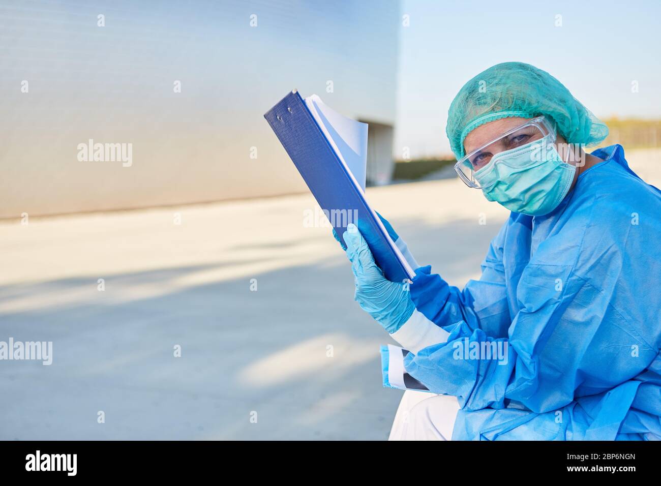 Gli infermieri di fronte alla clinica stanno studiando la lista di controllo dei contatti per il coronavirus o la pandemia di Covid-19 Foto Stock