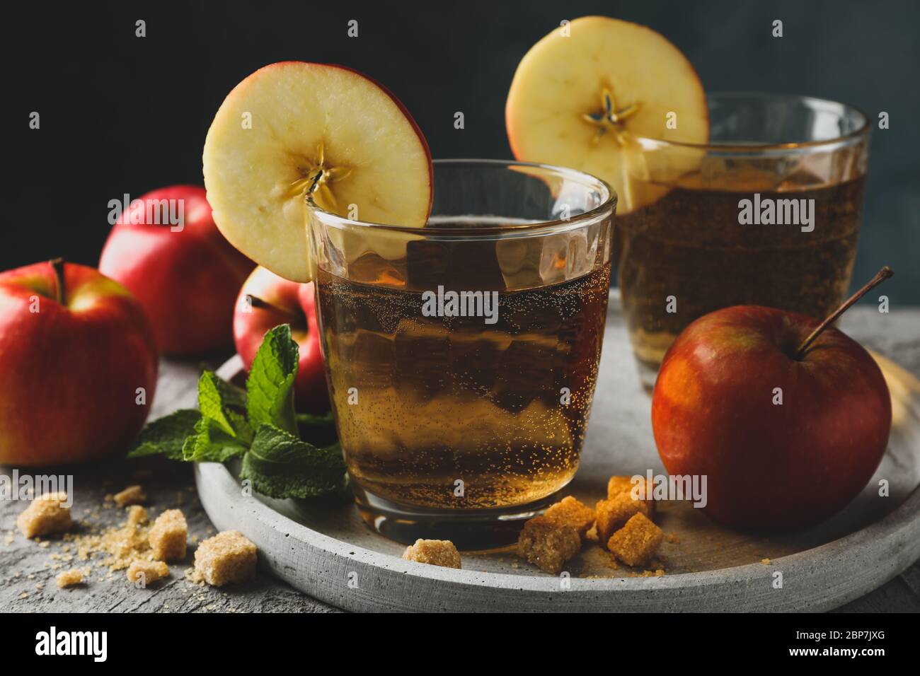 Composizione con sidro, zucchero e mele su tavola grigia Foto Stock