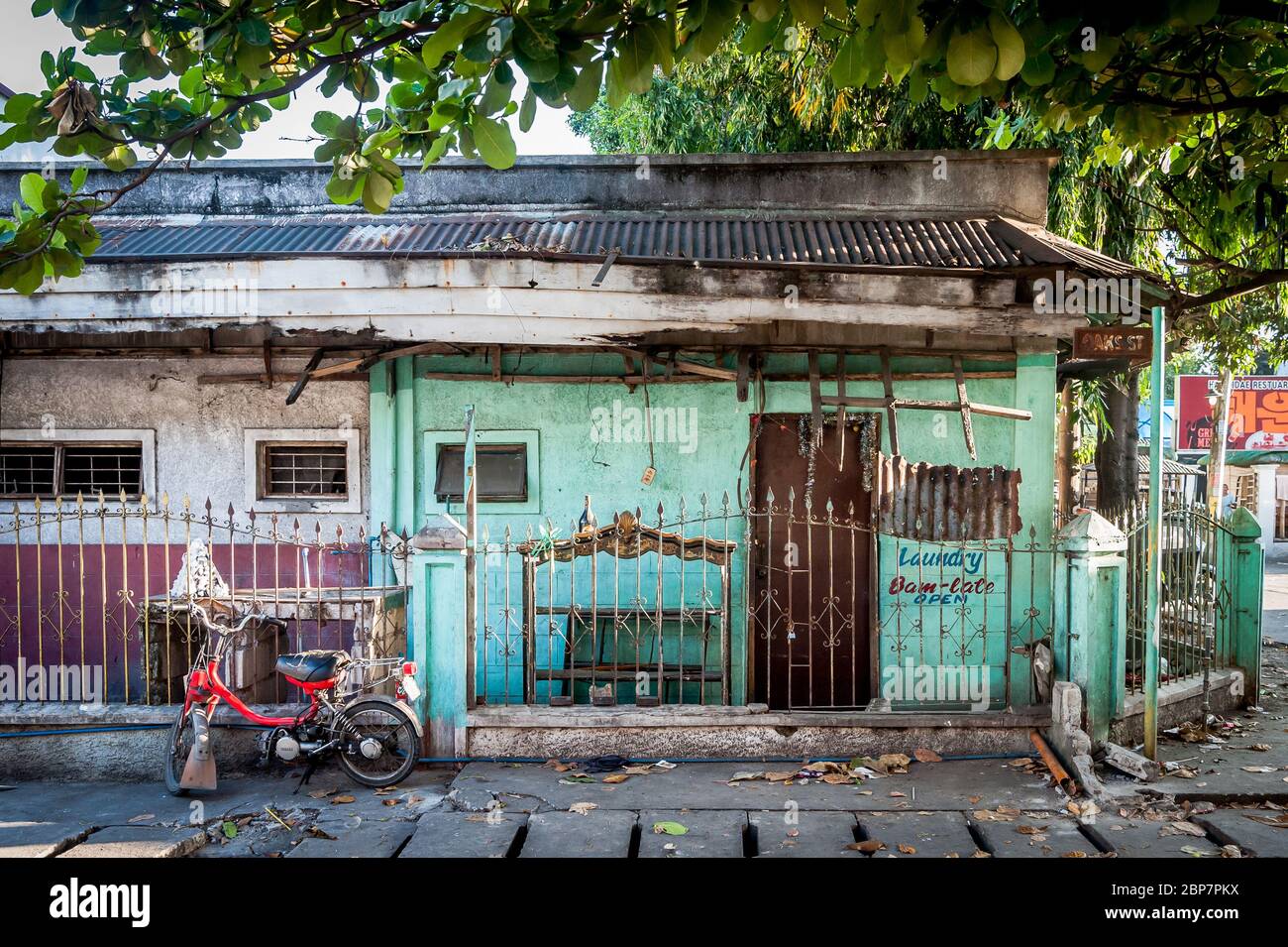 Una vecchia casa una volta usata come lavanderia in rovina a Angeles City Filippine. Foto Stock