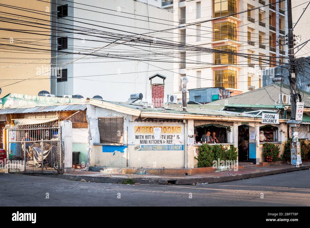 Uno dei più antichi bar e hotel di Angeles City Filippine si trova sotto il moderno sviluppo di appartamenti. Foto Stock