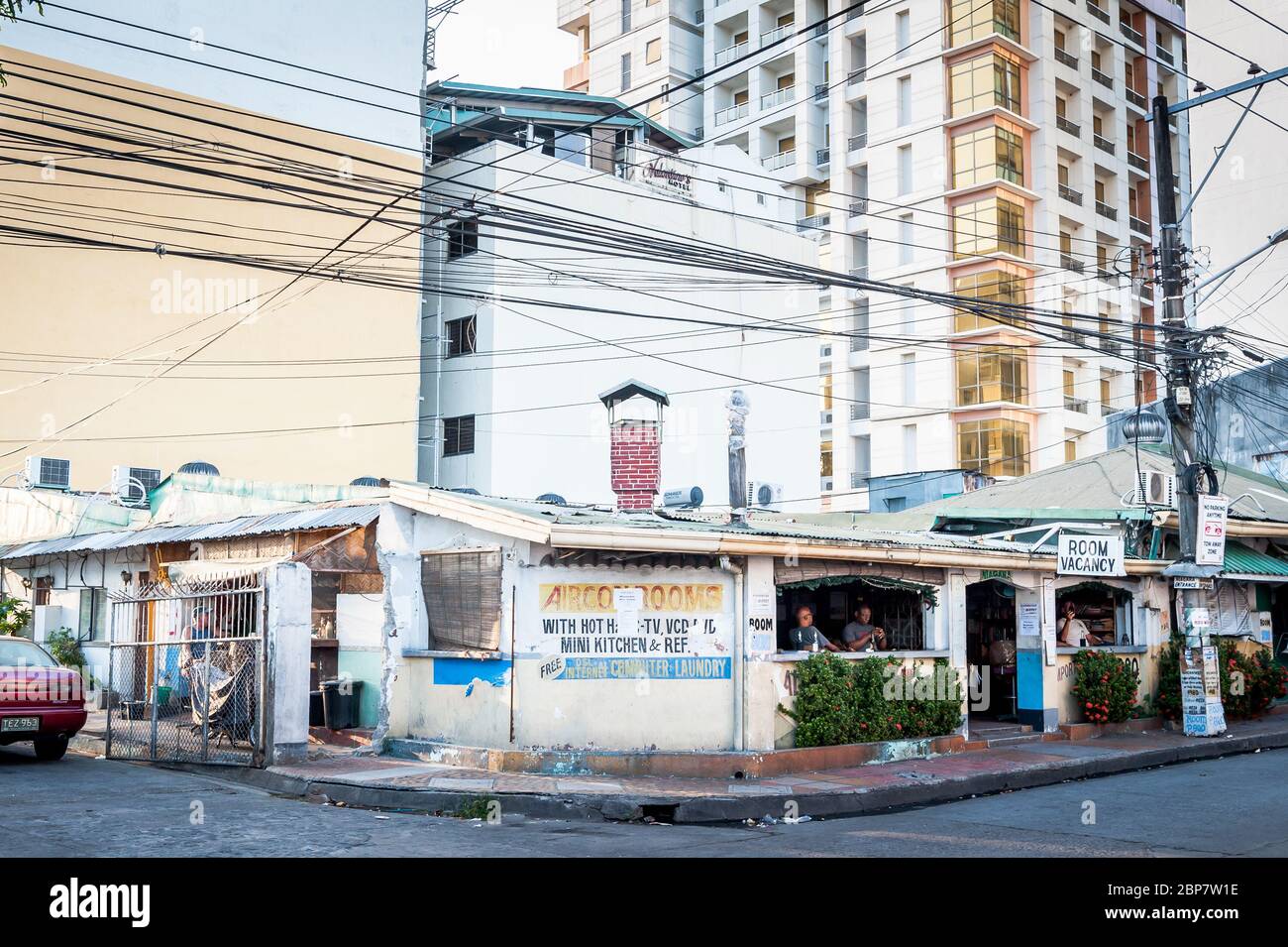 Uno dei più antichi bar e hotel di Angeles City Filippine si trova sotto il moderno sviluppo di appartamenti. Foto Stock
