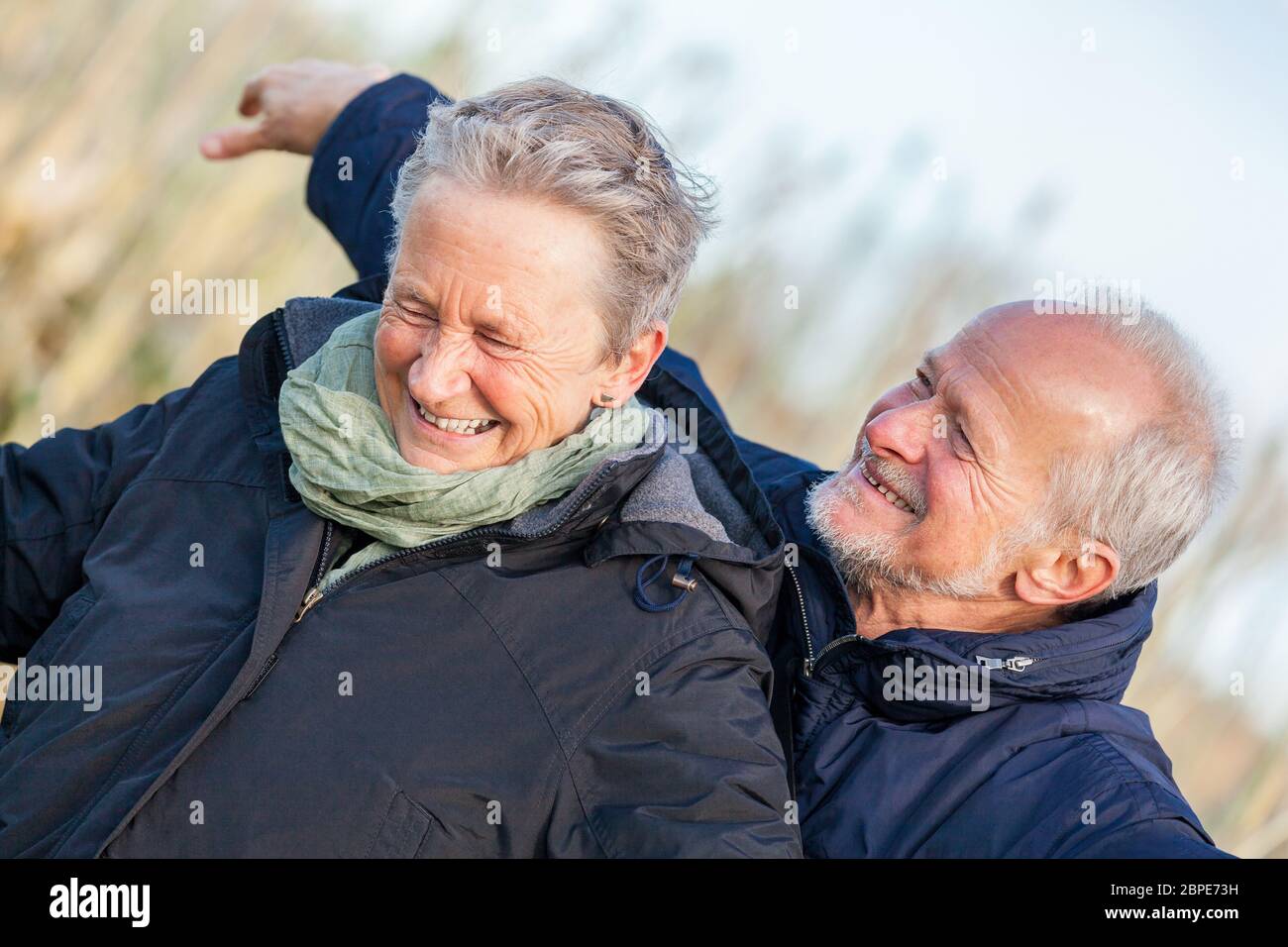 Senioren älteres paar glücklich lachend im urlaub freizeit natur ostsee Foto Stock