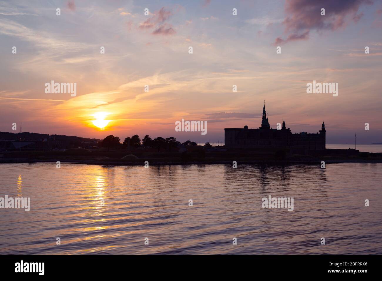 Il Castello di Kronborg silhouette in Helsingor al tramonto, Danimarca. Castello sulla riva a Helsingor. Porto danese di Helsingor con Kronborg Castle. Panora Foto Stock