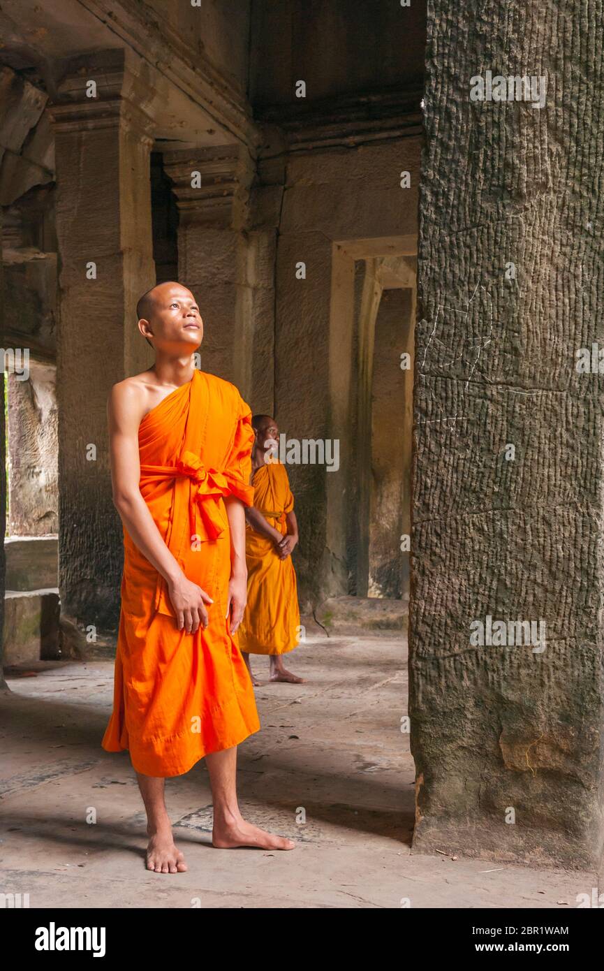 Un monaco guarda alla luce di Angkor Wat. Patrimonio dell'umanità dell'UNESCO, provincia di Siem Reap, Cambogia, Sud-est asiatico Foto Stock