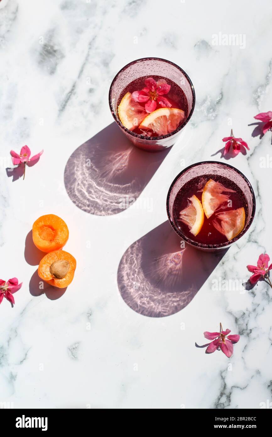 Due bicchieri di limonata rosa fatta in casa sotto una luce dura Foto Stock