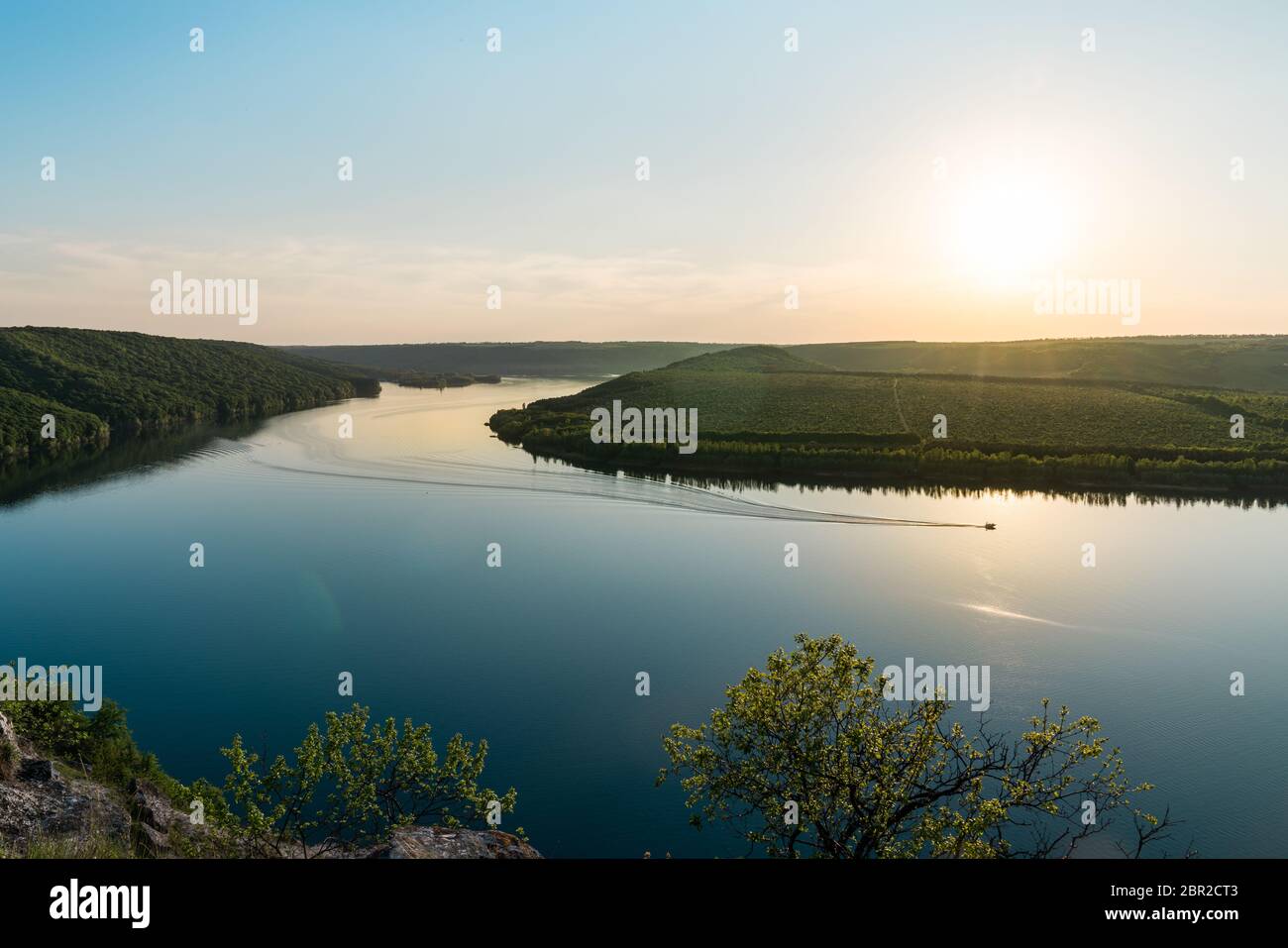 Panorama di un fiume tortuoso con un motoscafo galleggiante Foto Stock