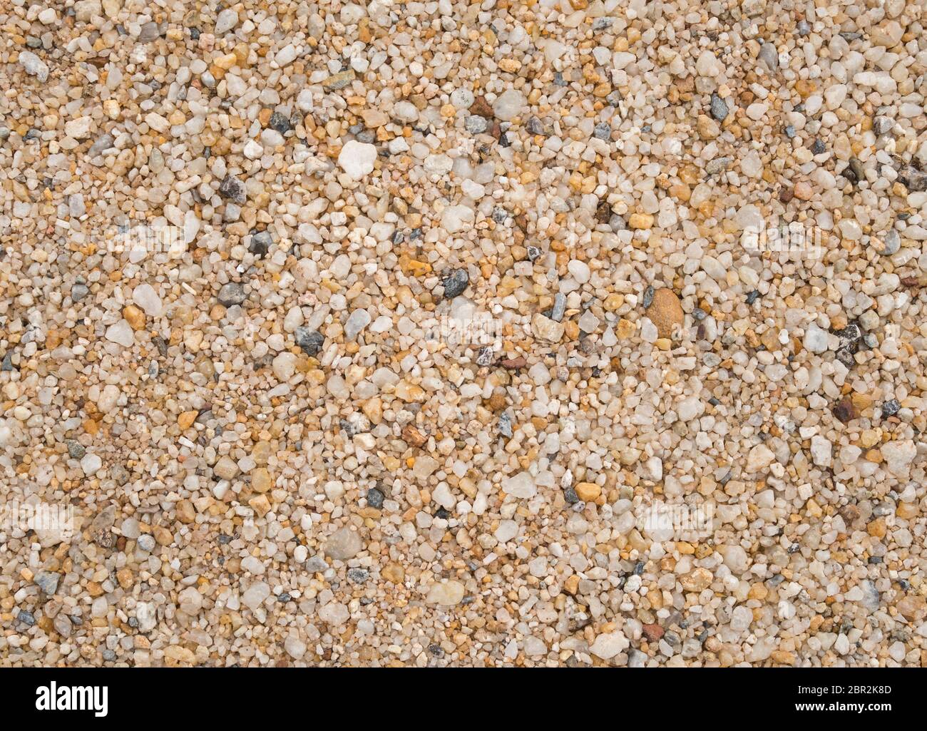Giallo sabbia ghiaia Texture di sfondo Design. Piccola ghiaia sabbia sfondo texture Foto Stock